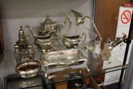 A plated three piece tea service, claret jug and other items.