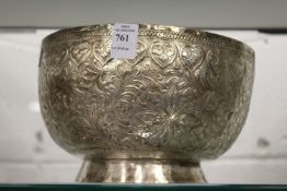 An eastern white metal bowl with embossed and engraved decoration.