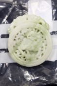 A Chinese carved jade roundel.