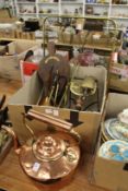 A large copper kettle and other metalware.