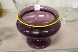 A good amethyst glass pedestal bowl with yellow edged rim and stem.