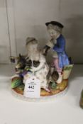 A 19th century Meissen style porcelain group of a boy and girl.