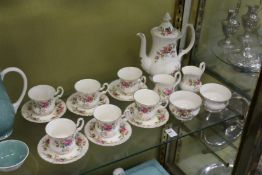 A Royal Albert Moss Rose coffee service comprising six cups and saucers, coffee pot, two milk jugs
