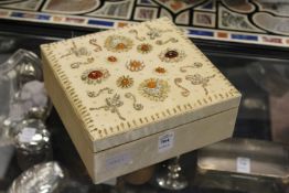 A decorative jewellery box with numerous items of jewellery.