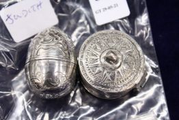 An engraved silver egg shaped case, possibly for a vinaigrette together with an eastern metal box.