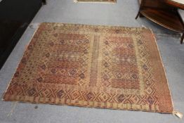 An old Persian carpet, worn.