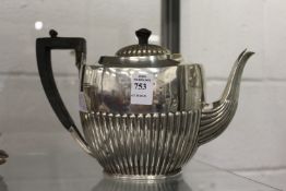 A silver teapot.