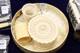 An early 20th century carved ivory box and cover and two other items.