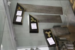 A graduated set of three ebony and brass carpenter's squares.