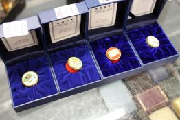 Four small Halcyon Days enamel boxes.