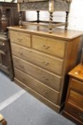 A large oak chest of drawers.