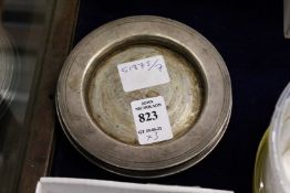 Three small silver dishes.