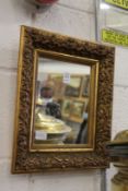 A small gilt framed mirror.