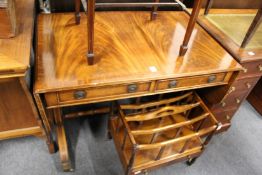 A reproduction mahogany sofa table.
