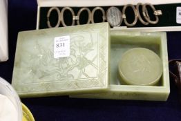A carved jadeite rectangular box and a similar circular box.
