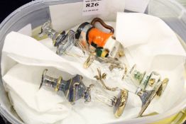 Miniature glass bottles and a Goss miniature Toby jug.
