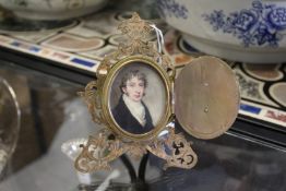 A good small late 19th century pierced and engraved ormolu strut photograph frame, the hinged