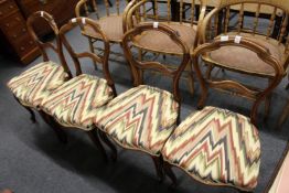 A set of four Victorian walnut hoop back dining chairs.