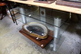 A glass TV and video stand.