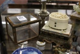 An early 20th century Chinese Canton carved ivory oval box with hinged lid housed in a display