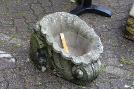 A composite garden cornucopia shaped planter.