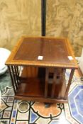 A good Edwardian inlaid mahogany revolving table top bookcase.