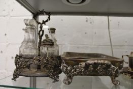 A six bottle cruet, lacking two bottles, together with a warming dish.