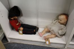 Two dolls, one dressed as a guardsman.
