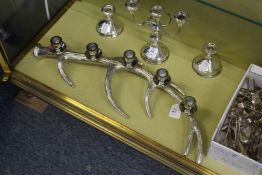 A decorative antler shaped plated candelabra.