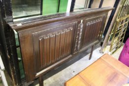 A carved oak linen fold decorative panel / headboard.