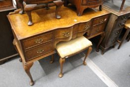 A figured walnut kneehole dressing table.