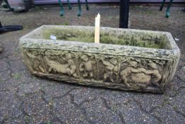 A composite rectangular garden planter.