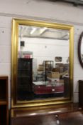 A large modern gilt framed mirror.