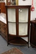 An inlaid mahogany bow front corner display cabinet.