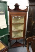 An Edwardian inlaid mahogany standing corner cabinet.