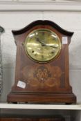 An inlaid mahogany mantle clock.