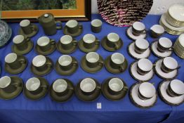 A large quantity of Denby cups and saucers and similar items.