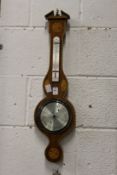 A modern barometer / thermometer with inlaid case.