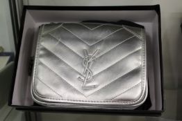 A ladies' silvered leather evening bag, boxed.