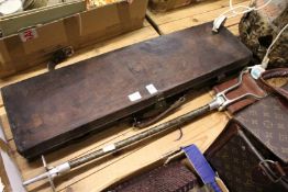 A gun case and a shooting stick.