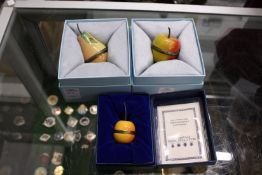 Three Halcyon Days fruit shaped enamel boxes.