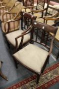 A pair of mahogany armchairs.
