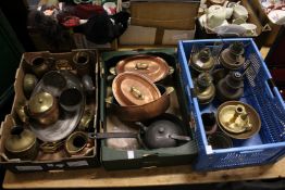 A collection of copper and brass ware together with various oil lamps.