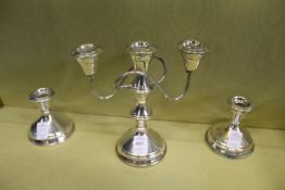 A plated three light candelabra with pair of matching candlesticks.
