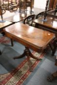 A good reproduction mahogany fold over card table on column support with quadruped base.