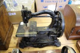 An early hand operated sewing machine.