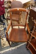 An Edwardian mahogany armchair.