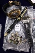 A watch, pen and other items.