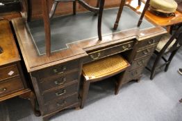 A mahogany kneehole desk.