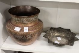 An Islamic copper vessel and a filigree dish.